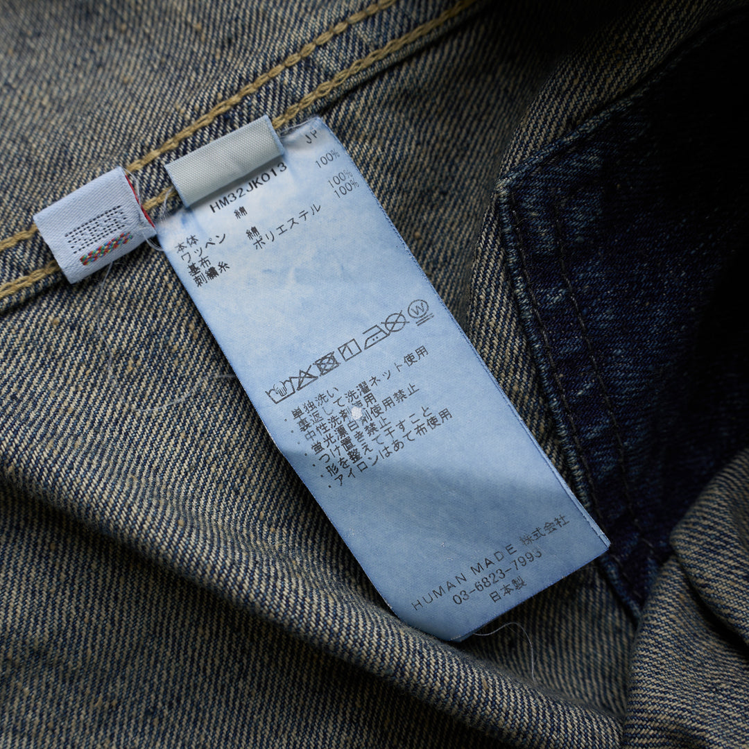 Human Made washed indigo denim work jacket with pleated front, button closure and heart-shaped logo patch on the chest - view 3