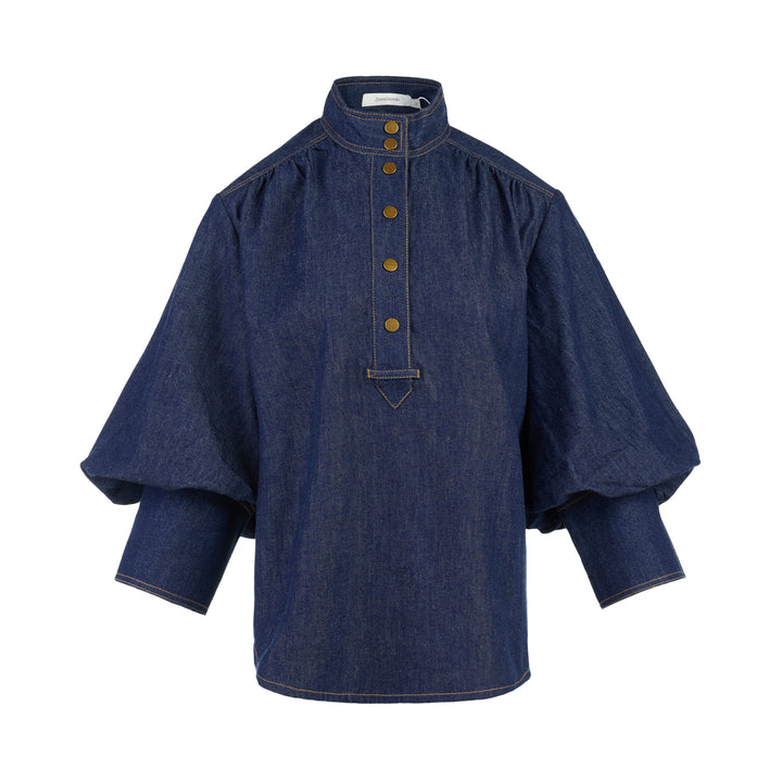 Zimmermann Denim Billow Shirt in dark indigo with stand collar, gold-tone buttons, contrast topstitching and balloon sleeves