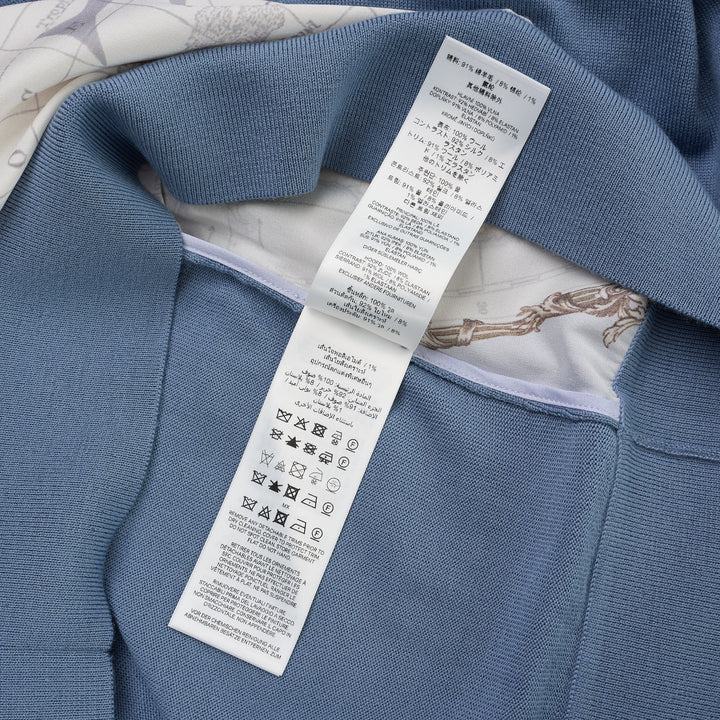 Zimmermann Valiant long sleeve polo with a silk front panel printed with a vintage world map and aeroplanes, framed by blue knit collar, sleeves, and hem - view 4