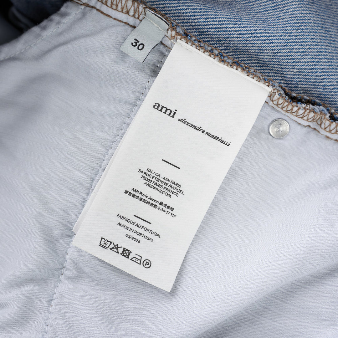AMI large fit jeans in light washed blue denim with a wide straight leg, five-pocket design and button fly, shown front view - view 3