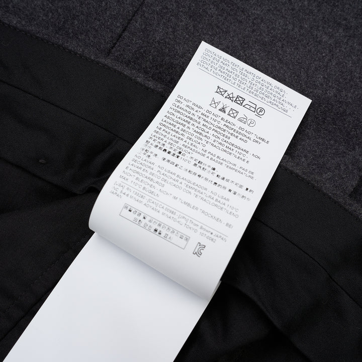 Thom Browne Fit 1 backstrap trousers in charcoal grey with flat front and slim straight leg, shown front view - view 4