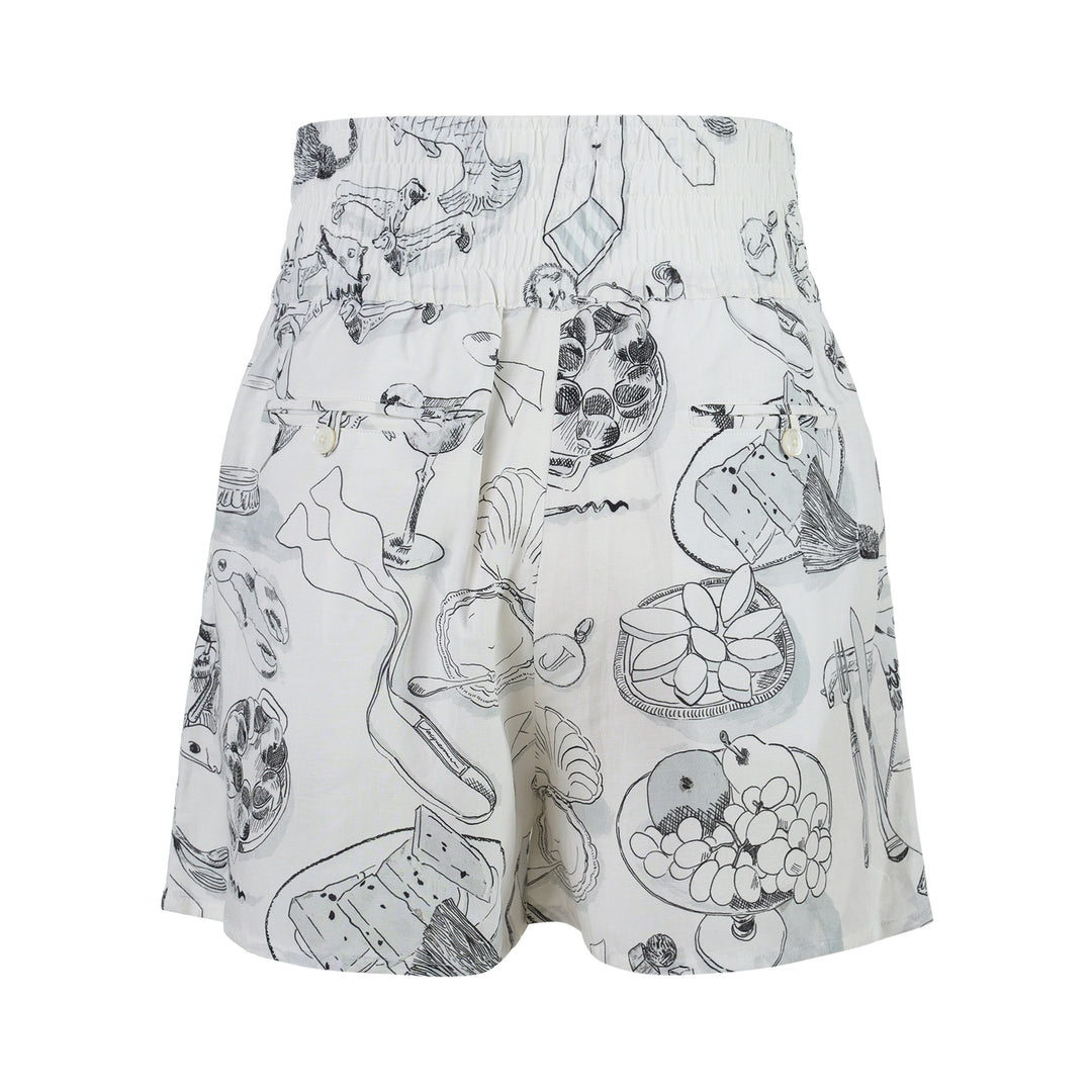 Jacquemus Le Boxer shorts in white with a black and grey illustrated print of shells, fish, grapes and champagne coupes, shown with a smocked high waistband - view 2