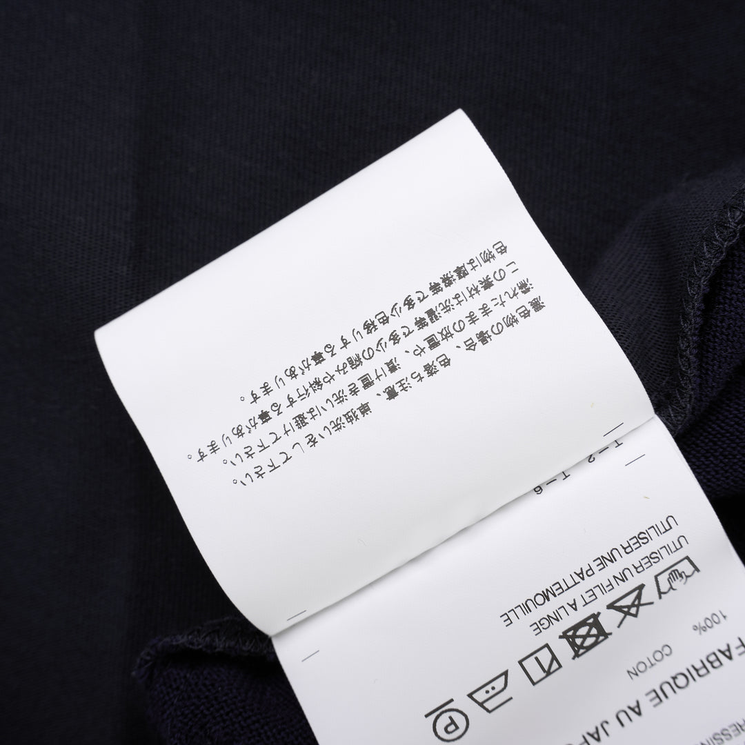 Comme des Garçons Homme navy fine-knit tee with contrasting black short sleeves, ribbed crew neck and hem, shown flat from the front - view 5