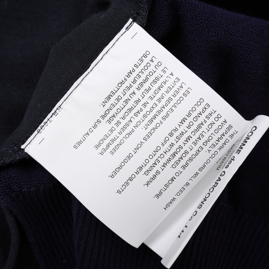 Comme des Garçons Homme navy fine-knit tee with contrasting black short sleeves, ribbed crew neck and hem, shown flat from the front - view 6