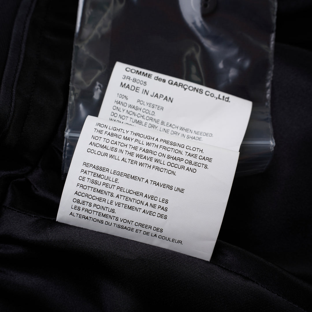 Noir Kei Ninomiya black satin blouse with ruffled stand collar, cascading ruffle placket, long sleeves and tiered peplum hem - view 4