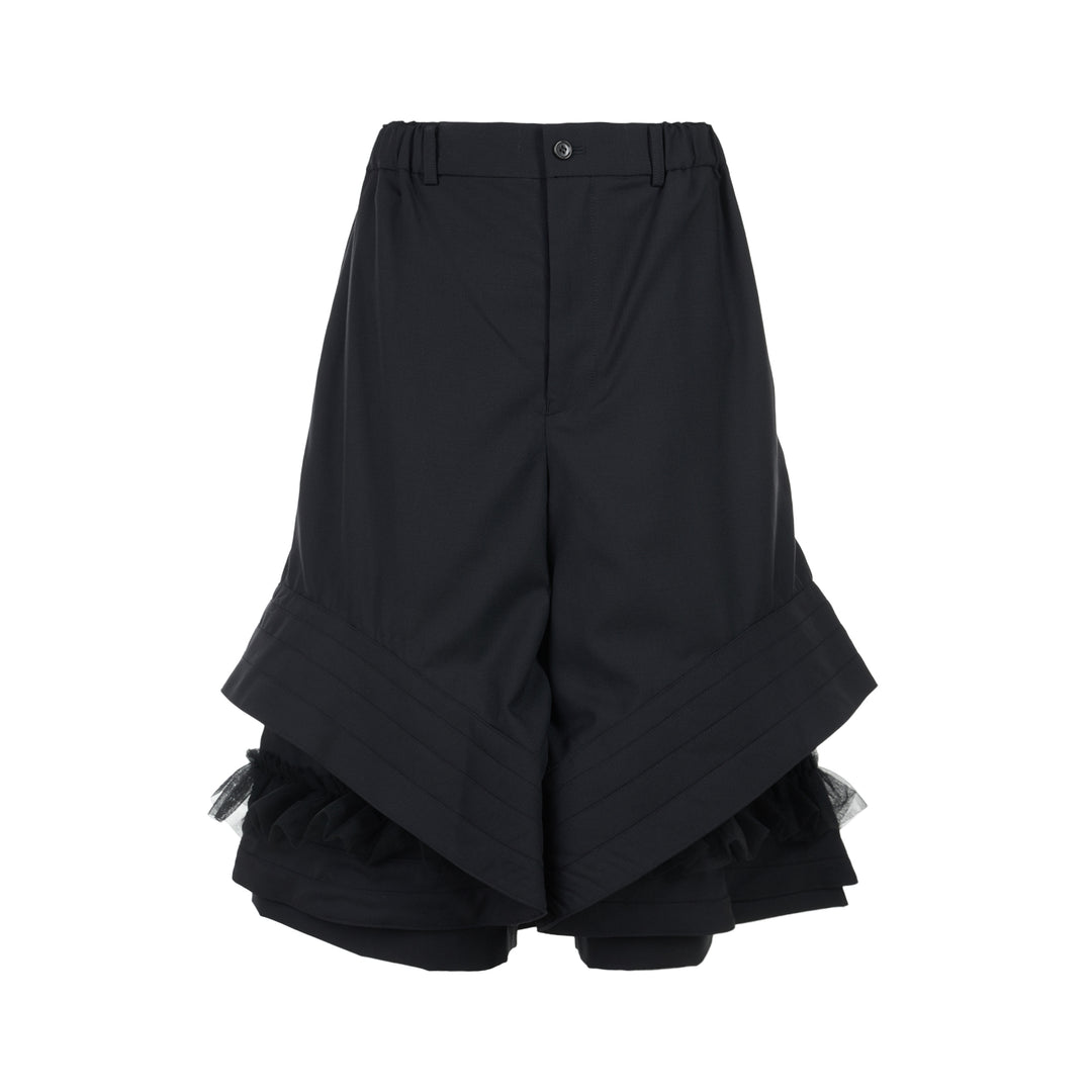 Noir Kei Ninomiya black wool tropical shorts with a stitched flared hem and layered black nylon tulle ruffles