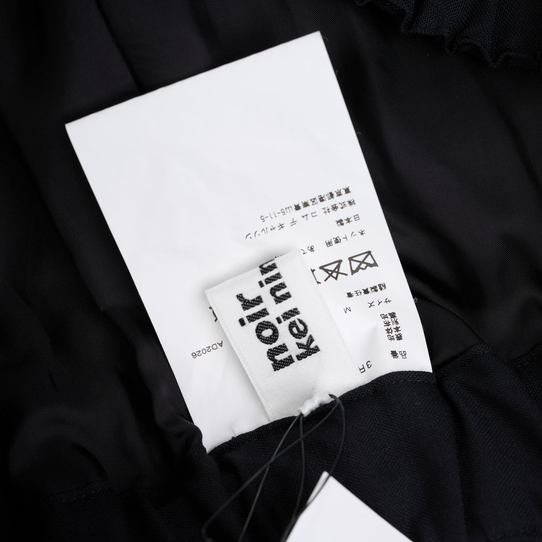 Noir Kei Ninomiya black wool tropical shorts with a stitched flared hem and layered black nylon tulle ruffles - view 4