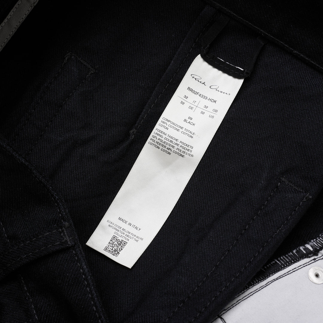 Rick Owens Geth Jeans in black denim with a wide-leg silhouette, shown from the front with button fly and five-pocket detailing - view 3