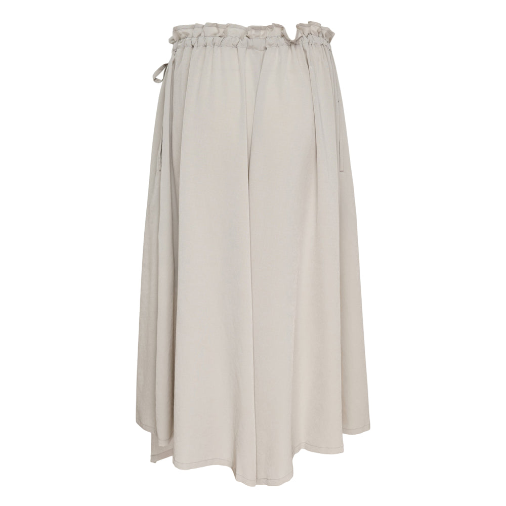 Y's black balloon draped midi skirt with drawstring waistband, asymmetric draped overlay panel, and fluid A-line silhouette, photographed on a white background
