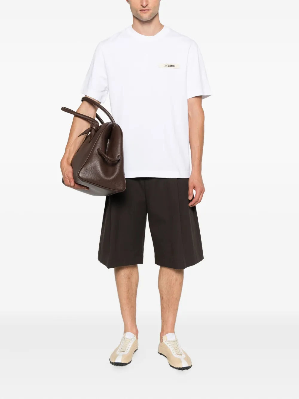 Jacquemus Le T-Shirt Gros Grain in cream with a grosgrain woven logo patch at the chest, laid flat on a white background