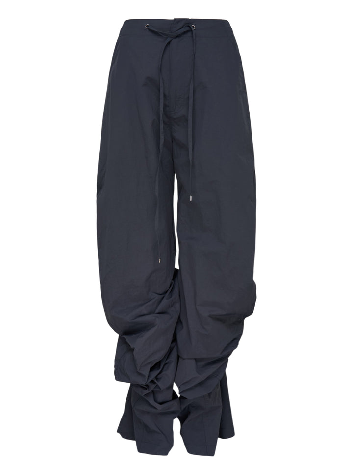 Dark navy wide-leg Nache nylon pants with a drawstring waist and ruched, pintucked hems, shown from the front