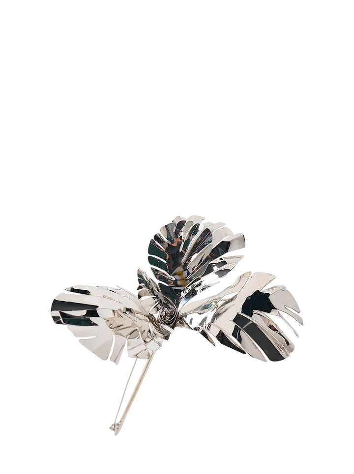 N°21 silver-tone metal brooch shaped as three polished, cut-out tropical leaves with a long pin fastening