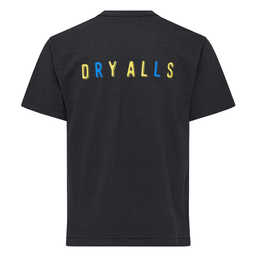 Human Made black short sleeve crew neck tee with large blue heart graphic print reading 'Human Made' in yellow and white outlined lettering, with colour-blocked accent stripes at the shoulder