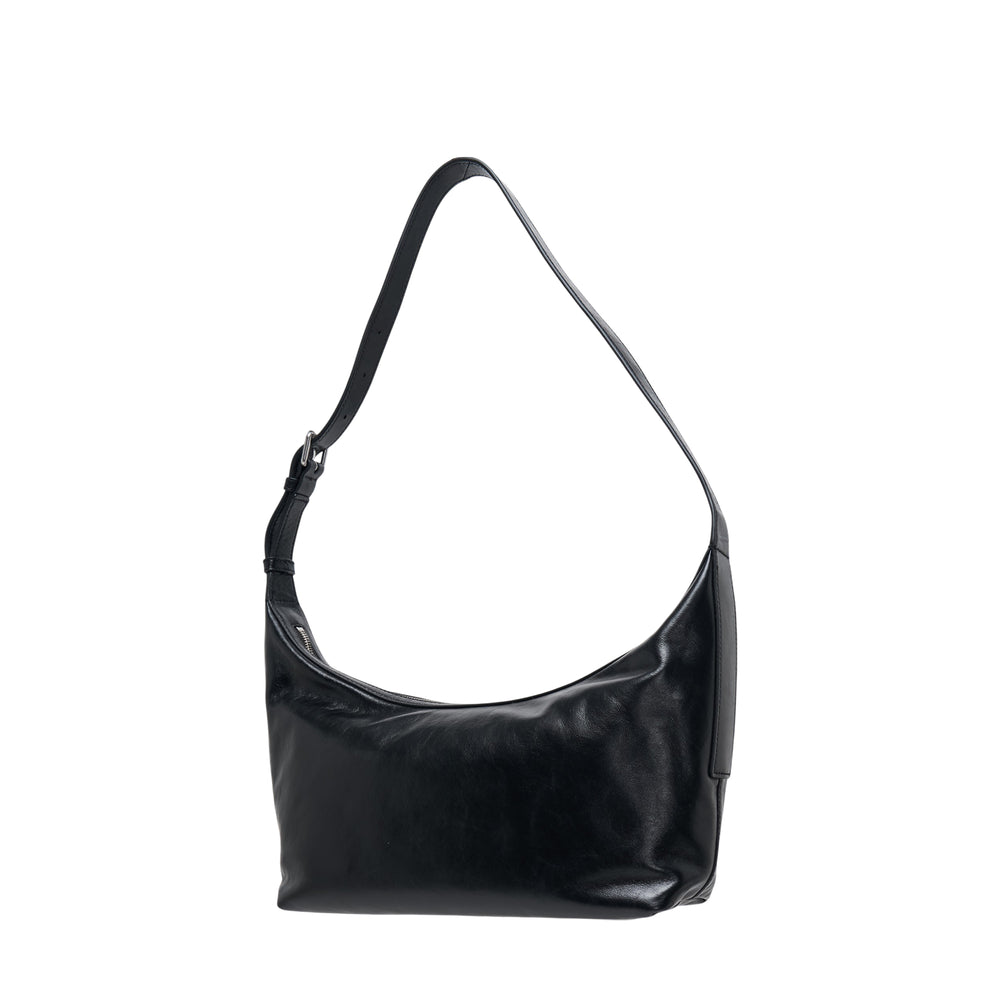 Alexander Wang Punch Sling Bag in black high-gloss leather with crescent silhouette, adjustable shoulder strap, and embossed tonal logo on the front