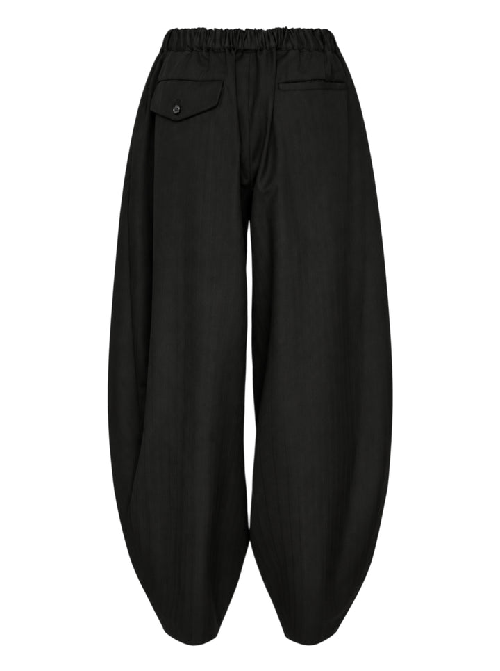 Comme des Garçons Black pleated balloon trousers in black polyester and wool herringbone with an elasticated waist, shown from the front - view 2