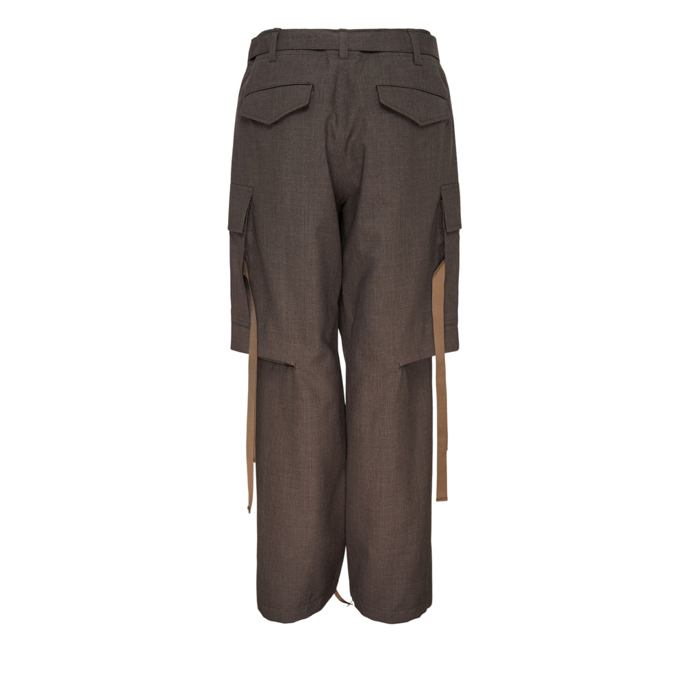 sacai black suiting cargo pants with wide-leg silhouette, oversized flap pockets, belted waist, strap hardware, and drawstring hem