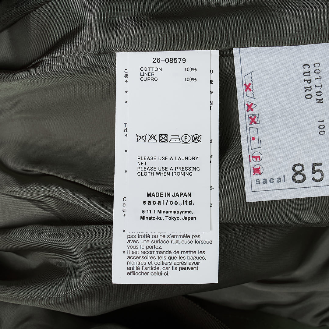 sacai Cotton Weather Cargo Shorts in olive green with wide-leg silhouette, front pleats, patch cargo pockets, and integrated buckle belt - view 3