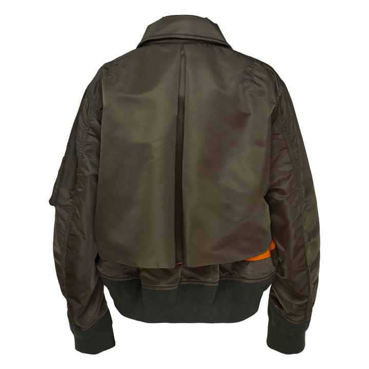 sacai Nylon Twill Bomber Blouson in olive green, featuring dual zip closure, contrast amber yellow hem lining, angled chest pockets, and ribbed knit trims, displayed flat on a white background - view 2