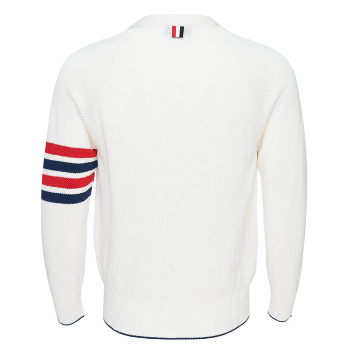 Thom Browne white tuck stitch relaxed cardigan with signature red, white, and blue 4-bar stripe on the sleeve, V-neckline, button-front fastening, and hip patch pockets