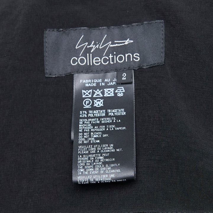 Yohji Yamamoto Stole Detail Single Jacket in black, featuring wide lapels, a single-button closure, an elongated stole panel at the front, and hip flap pockets