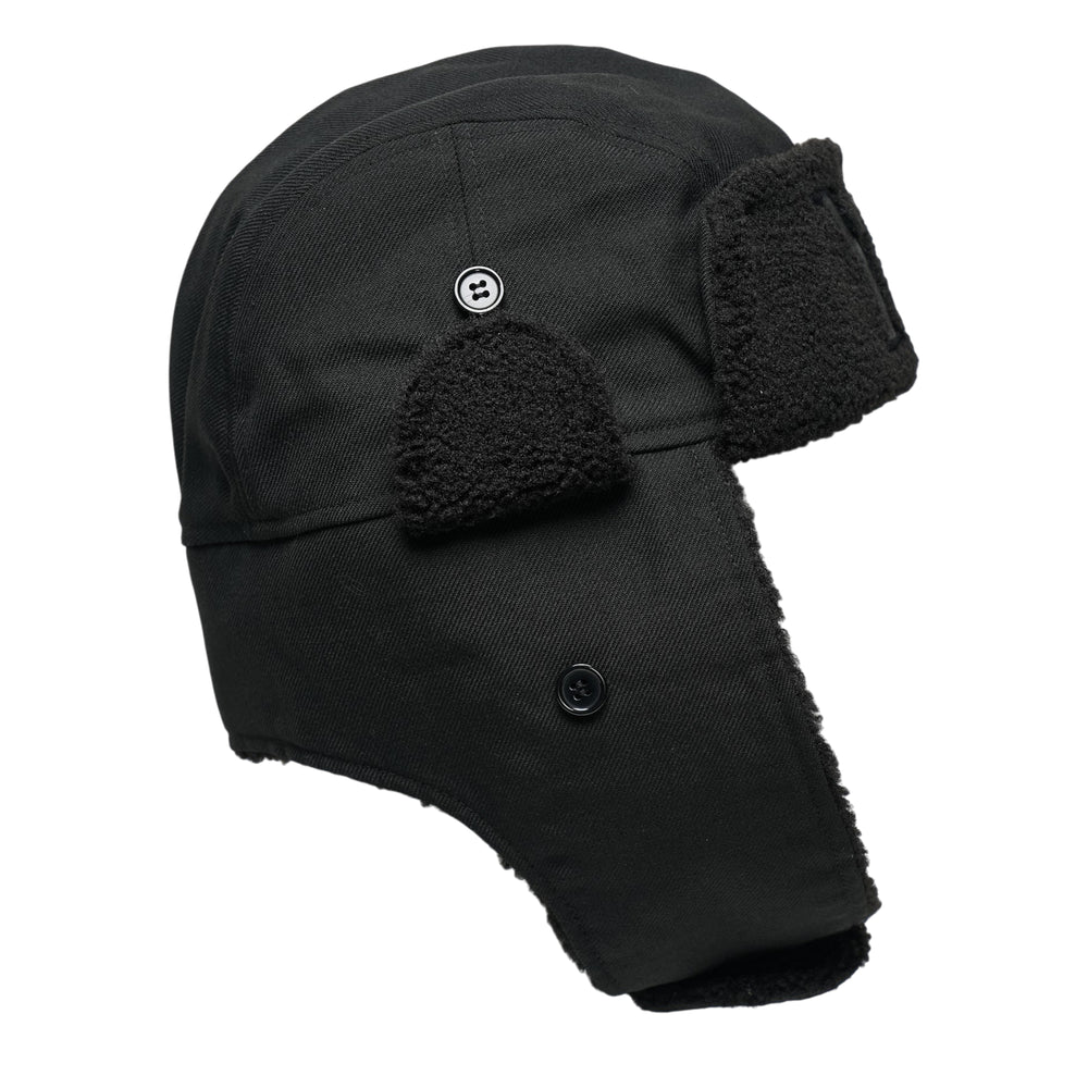 Y's all-black wool trapper hat with sherpa fleece lining, fold-down ear flaps with chin strap, and tonal embroidered Y's logo on the front panel, photographed from the front on a white background. - view 2