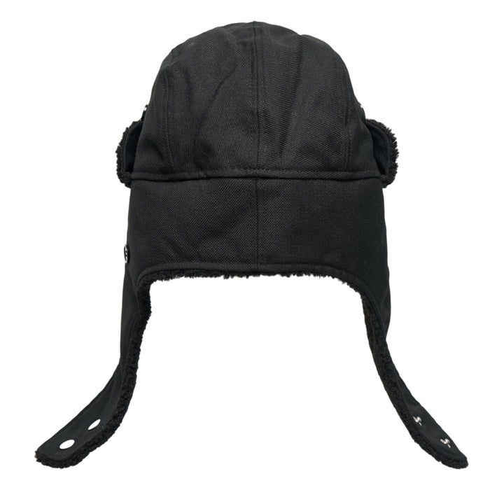 Y's all-black wool trapper hat with sherpa fleece lining, fold-down ear flaps with chin strap, and tonal embroidered Y's logo on the front panel, photographed from the front on a white background. - view 3