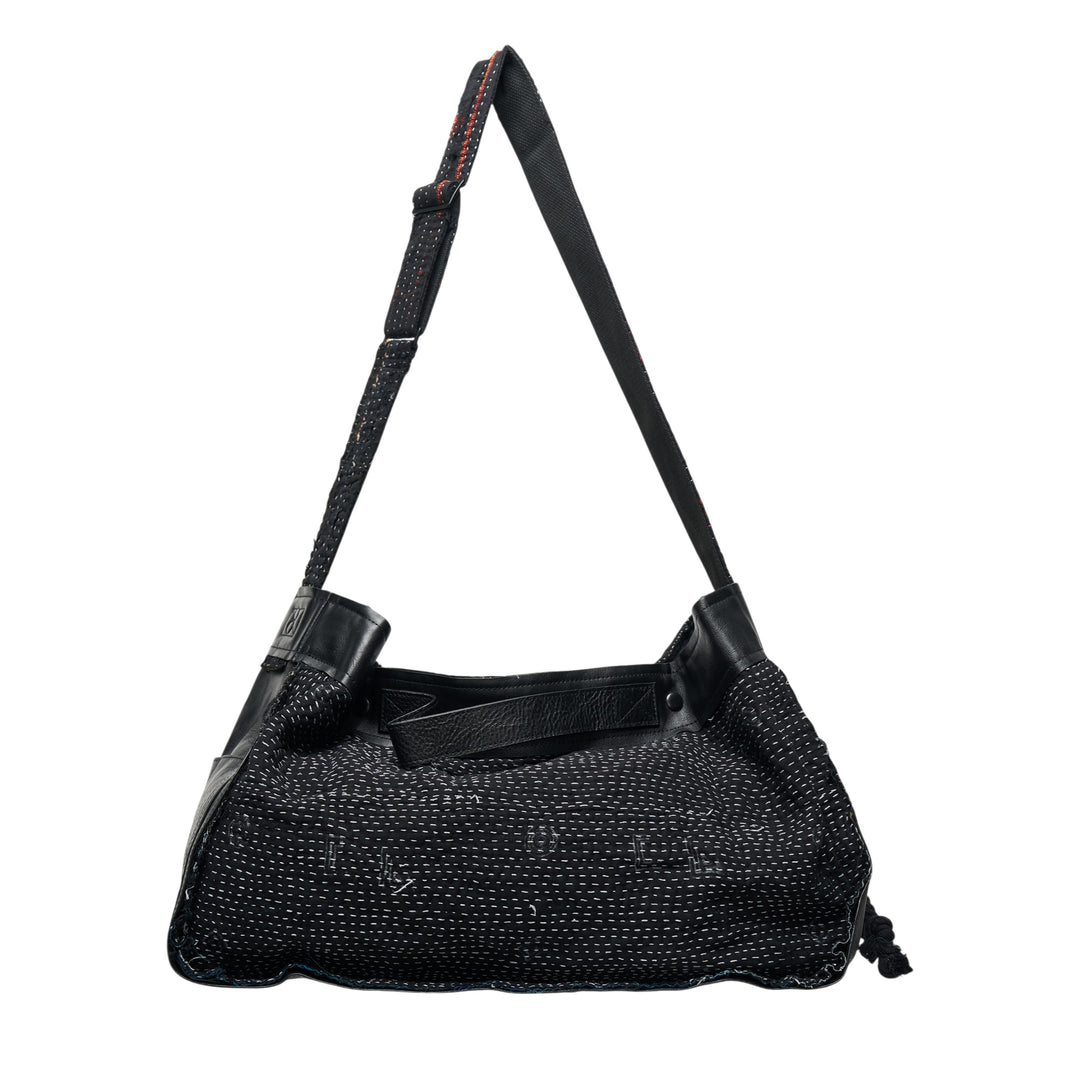 Y's x FAF 001 black shoulder bag with all-over running stitch quilted textile body, leather frame trim, adjustable strap with contrast red stitching, and drawstring corner closure