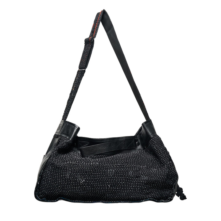 Y's x FAF 001 black shoulder bag with all-over running stitch quilted textile body, leather frame trim, adjustable strap with contrast red stitching, and drawstring corner closure