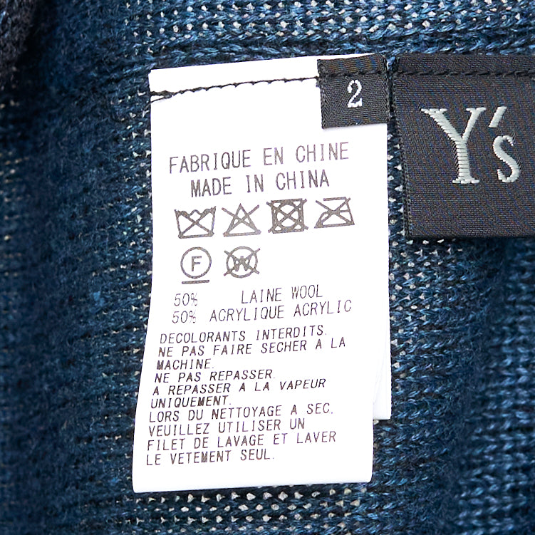 Y's high neck semi-sheer fine-knit top in deep navy with an asymmetric diagonal teal contrast cloth panel and raw-edge detailing, long sleeves, front view