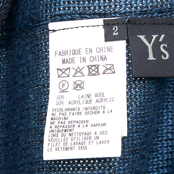 Y's high neck semi-sheer fine-knit top in deep navy with an asymmetric diagonal teal contrast cloth panel and raw-edge detailing, long sleeves, front view