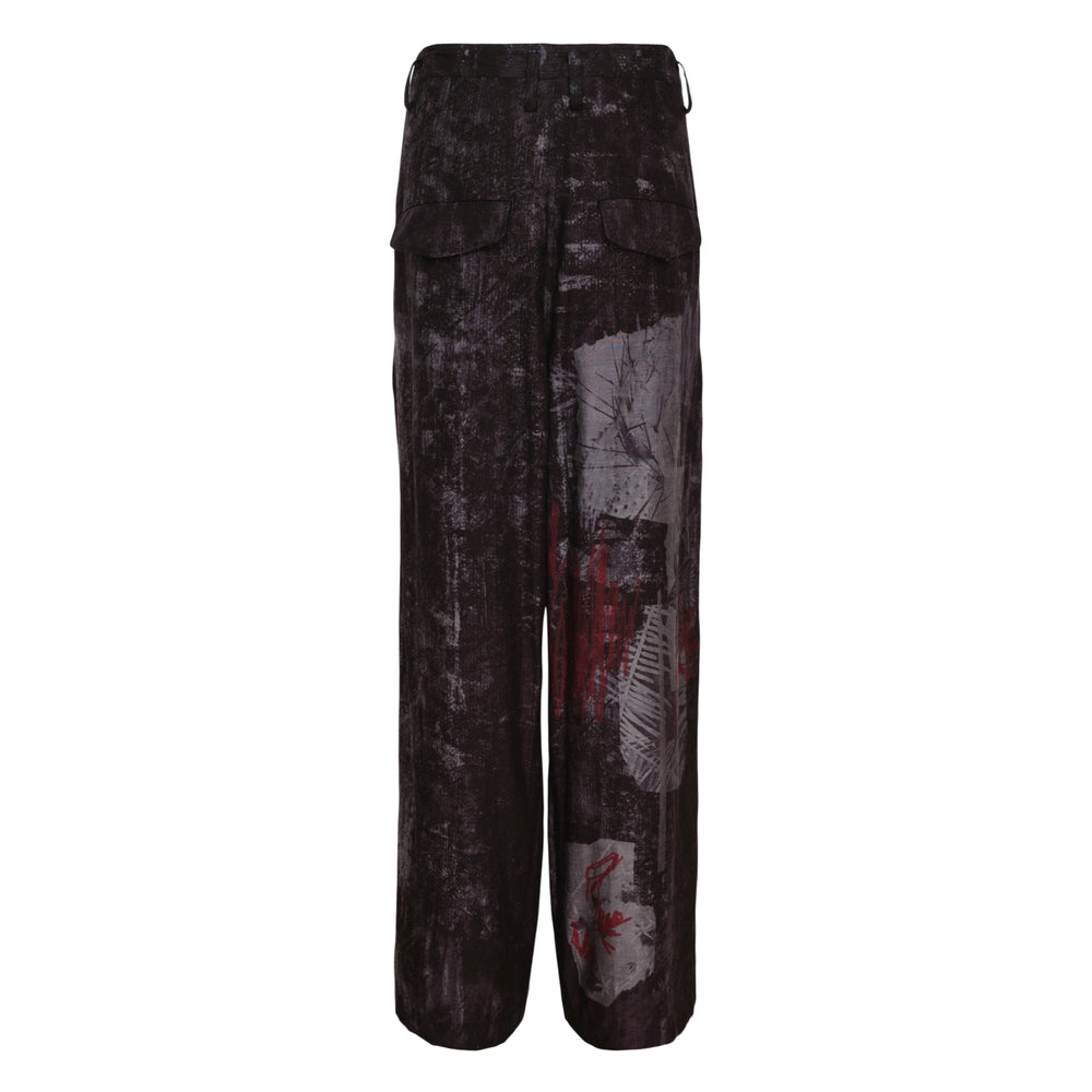 Y's Tuck Loose Wide Pants with dark abstract graphic print featuring distressed texture and crimson brushstroke details, high-rise waistband with single button, and pleated wide-leg silhouette