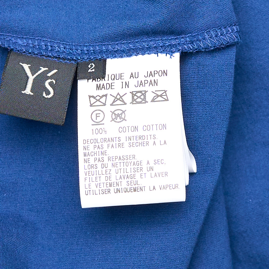 Y's cobalt blue long-sleeve cardigan with asymmetric draped overlay panel and ruched drawstring cinch detail at the side, shown on a flat lay against a white background