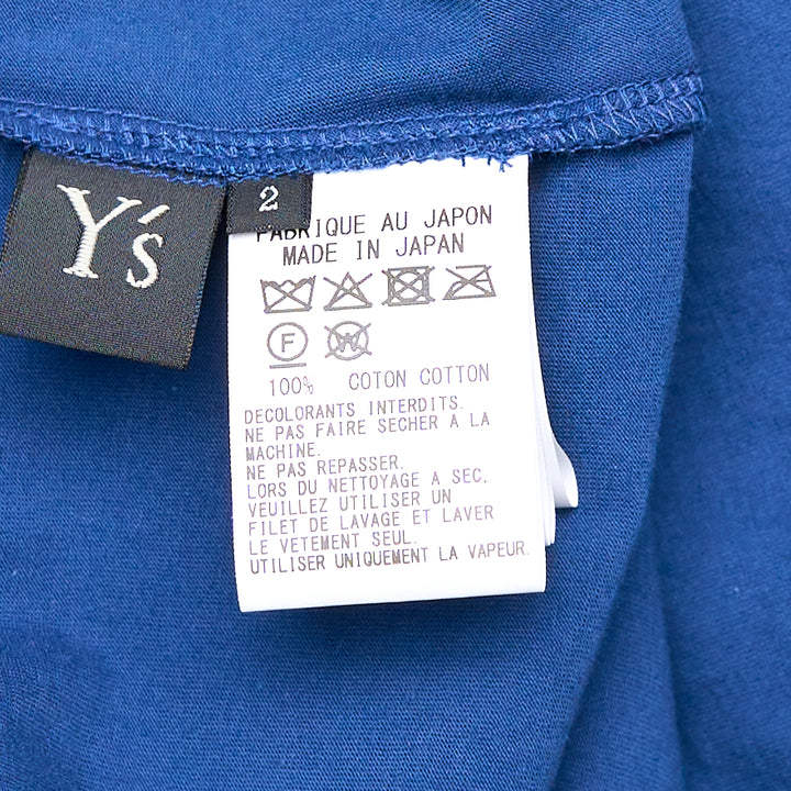 Y's cobalt blue long-sleeve cardigan with asymmetric draped overlay panel and ruched drawstring cinch detail at the side, shown on a flat lay against a white background