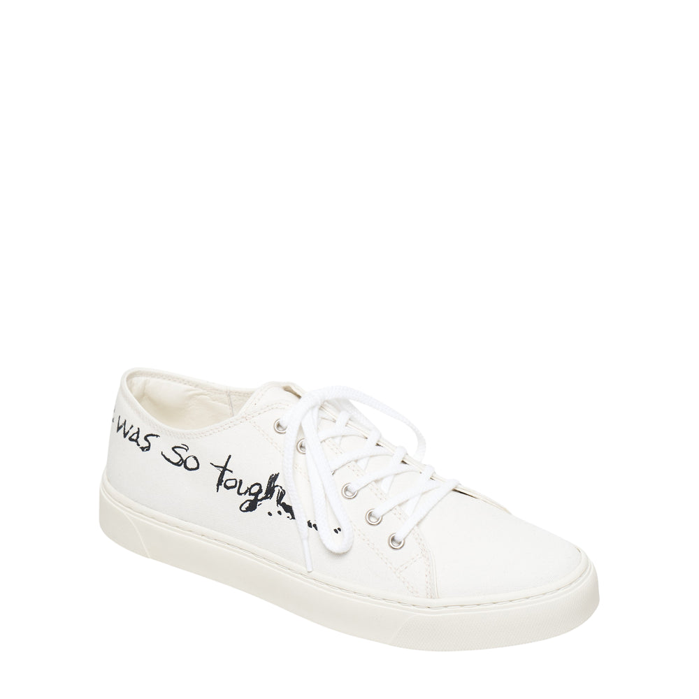 Y's off-white low-cut canvas sneaker with handwritten 'she was so tough...' script graphic along the upper, white lace-up closure and tonal rubber sole