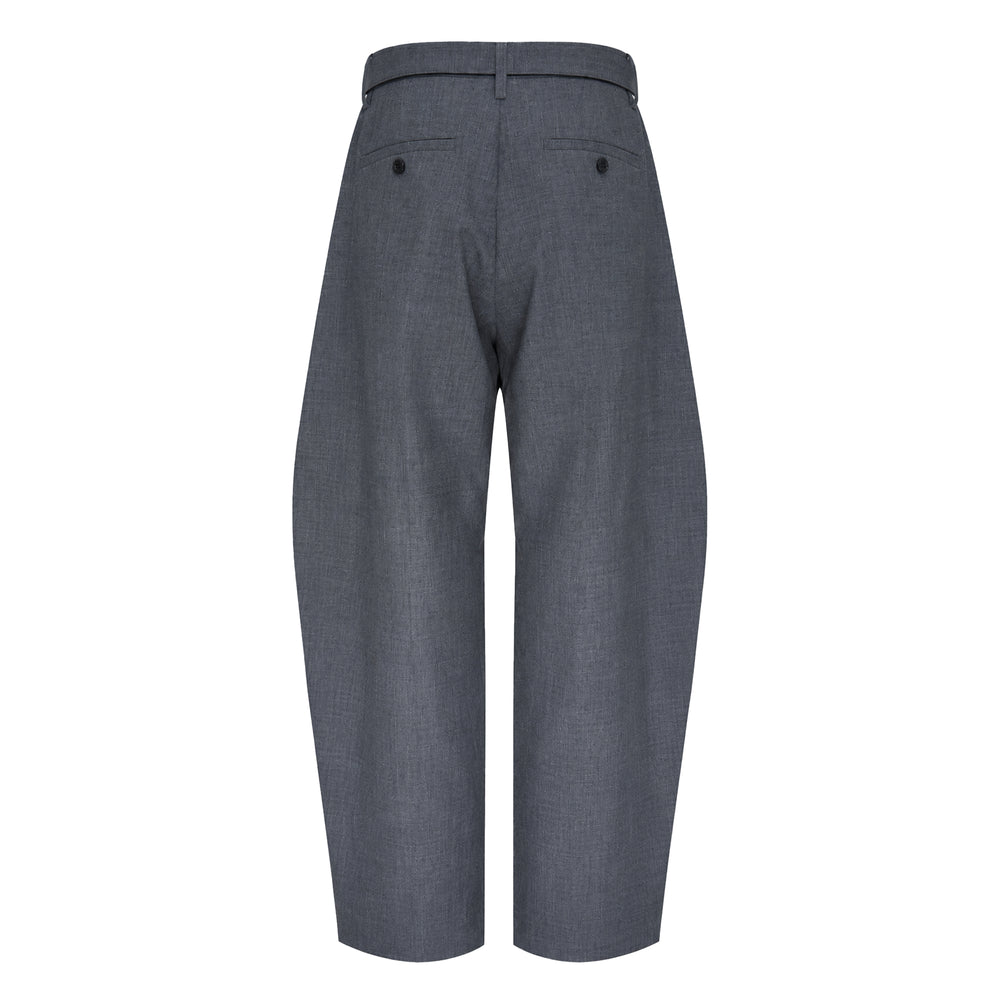sacai Belted Suiting Pants in black, featuring a sculptural barrel-leg silhouette, front pleating, and an integrated self-fabric belt with a gunmetal-tone buckle