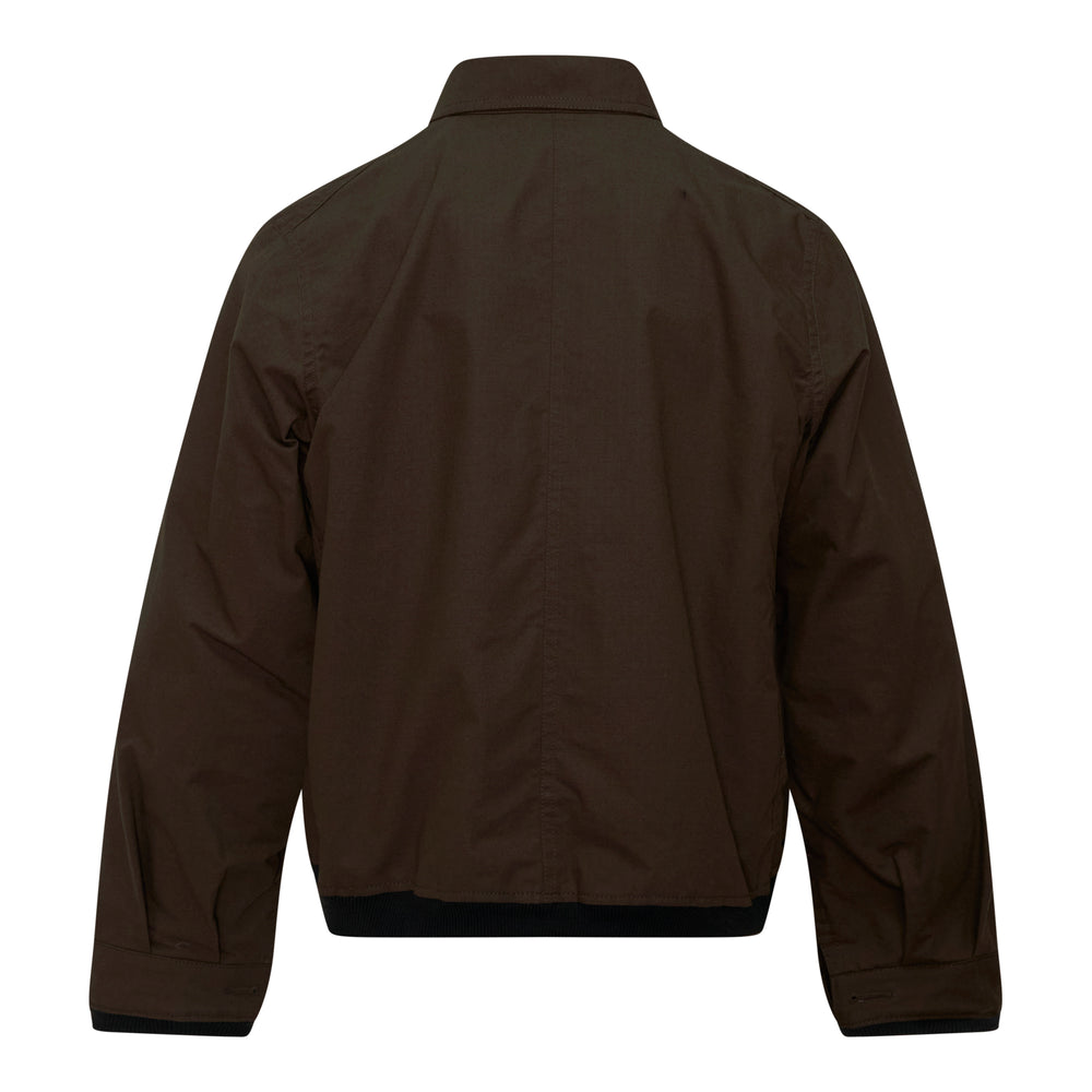 sacai Nylon Twill Reversible Blouson in olive brown with quilted black ripstop lining visible along the button-front placket, ribbed cuffs, and hem band