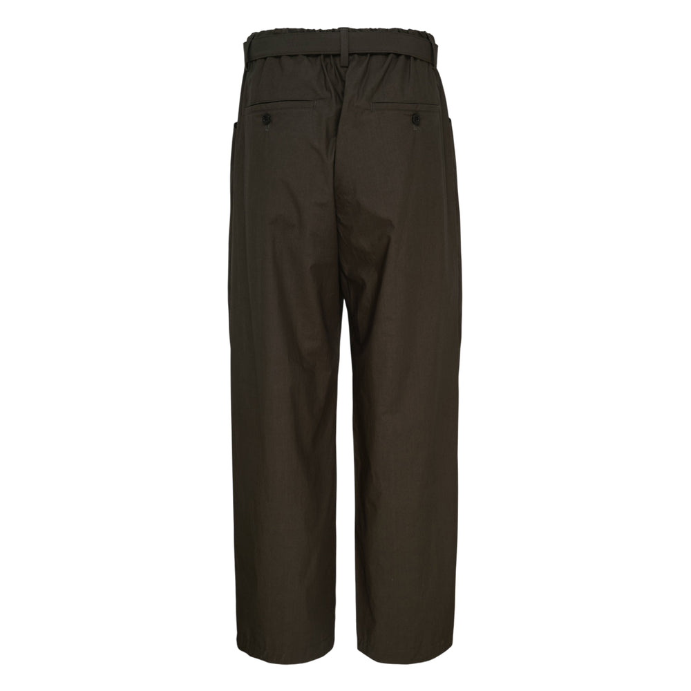 sacai Cotton Typewriter Pleated Pants in dark brown with deep front pleats, large hip patch pockets, and a contrast olive webbing belt with metal buckle