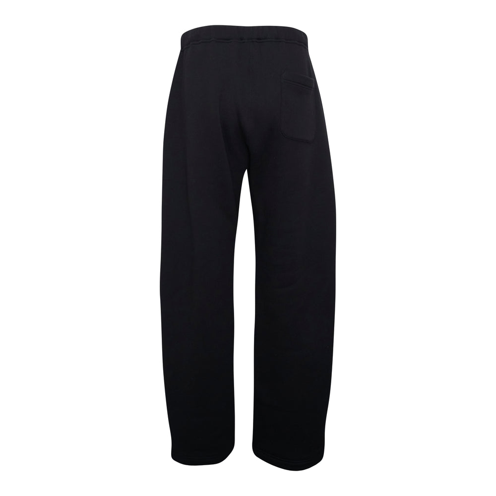 sacai Cotton Jersey Pants in black, featuring a wide-leg silhouette, structured high-rise waistband, and single button fastening, shown flat on a white background