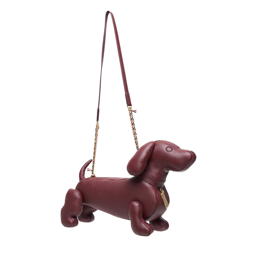 Thom Browne Mini Hector dachshund crossbody bag in dark burgundy pebbled leather with woven gold-tone chain strap and signature red, white, and blue grosgrain trim