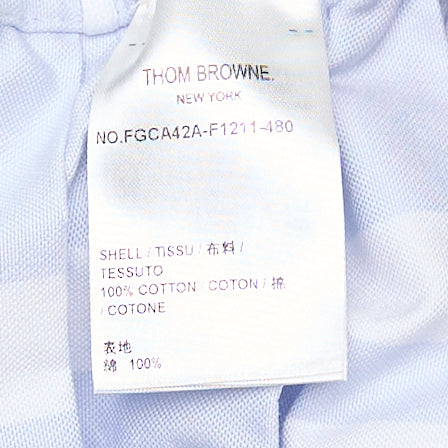 Thom Browne pale blue mini pleated skirt with white drawstring waistband, signature 4-bar stripe, and woven brand label