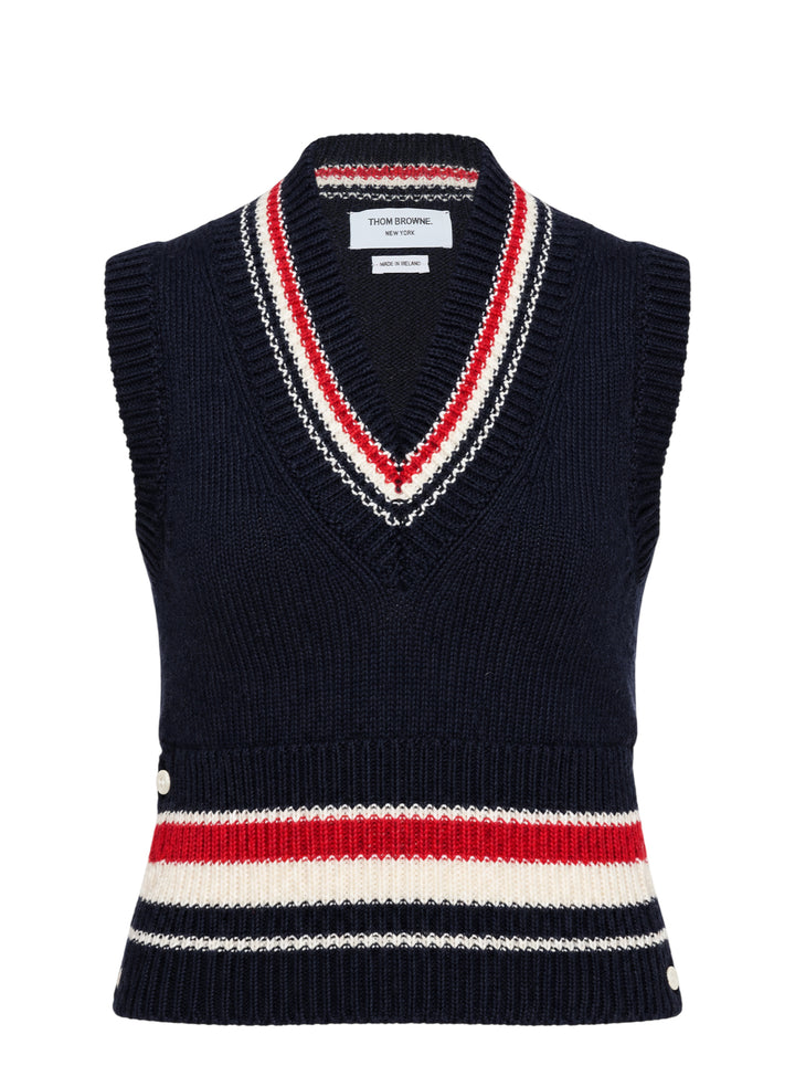 Thom Browne navy chunky-knit V-neck vest with red, white, and blue intarsia stripes at the neckline and hem and pearl buttons at the hem