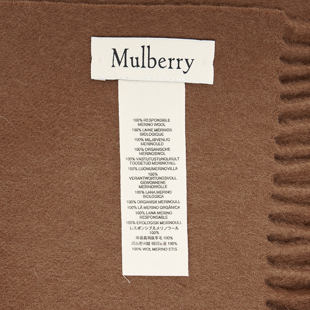 Mulberry Small Solid Merino Wool Scarf in tan with fringed ends and tonal embroidered branding, laid flat on a white background