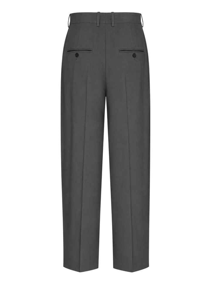 Totême High-Waist Pleated Trousers in charcoal grey, featuring front double pleats, a wide-to-tapered leg, and a structured high-rise waistband, shown flat on a white background - view 2