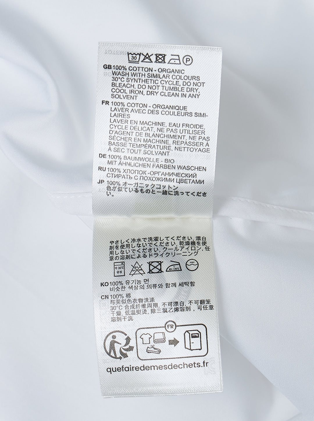Totême Boxy Poplin Shirt in white, featuring a pointed collar with woven monogram label, full button fastening, long sleeves with barrel cuffs, and a relaxed oversized silhouette - view 3