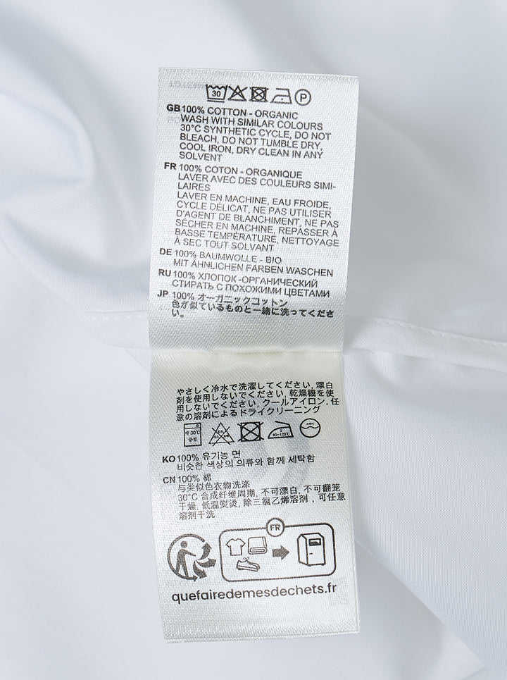 Totême Boxy Poplin Shirt in white, featuring a pointed collar with woven monogram label, full button fastening, long sleeves with barrel cuffs, and a relaxed oversized silhouette - view 3