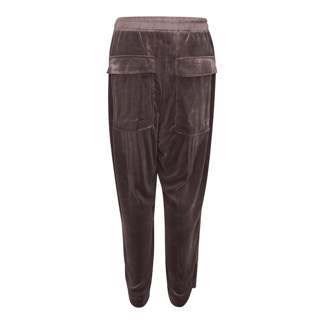 Rick Owens Drawstring Astaires Cropped Pants in black, displayed flat, featuring a dropped-crotch silhouette, pressed front crease, elasticated waistband with contrast ivory drawstring, and tapered cropped hem.