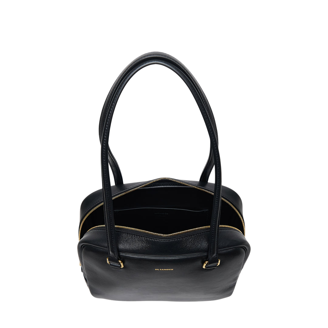 Jil Sander Vision Medium tote bag in black nappa lambskin leather with dual shoulder straps, gold-tone zip closure and D-ring hardware, front view on white background