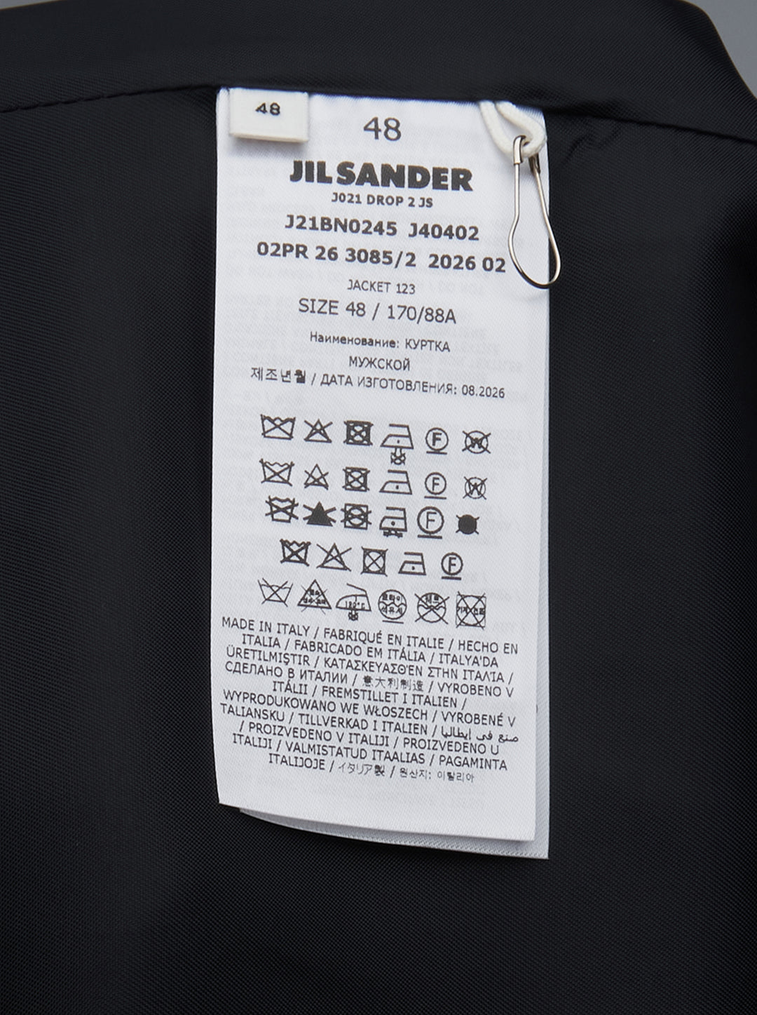 Jil Sander navy fil-a-fil wool jacket with camp collar, four-button fastening, and curved flap pockets with metal hardware — front view on white background - view 3
