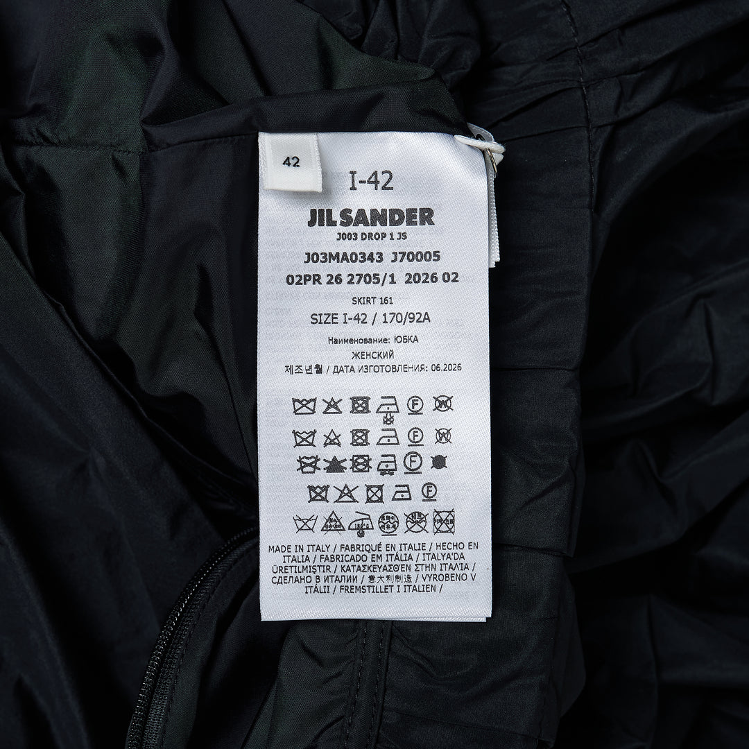 Jil Sander black recycled light polyester skirt with gathered waistband, dramatic draped front panel, and asymmetric hem, shown on white background