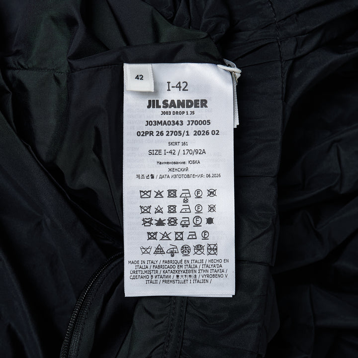 Jil Sander black recycled light polyester skirt with gathered waistband, dramatic draped front panel, and asymmetric hem, shown on white background
